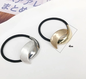 Detail showing minimalist 4cm gold and silver metallic ponytail cuff hair ties