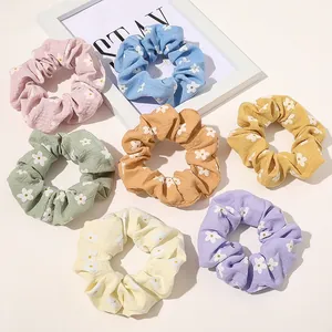 Detailed set of seven colorful floral scrunchies with pleated texture for ponytails