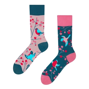 Detailed view of mismatched crew socks with colorful bird and berry jacquard patterns