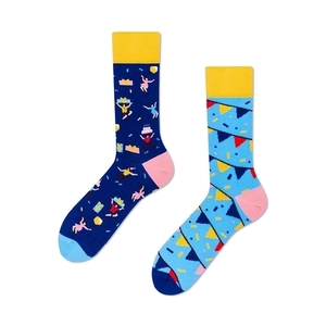 Detail view of colorful asymmetric cotton socks featuring party patterns and blue heels
