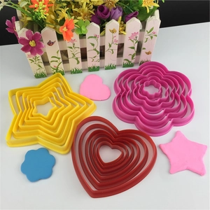 Macro view of multi-size 3D heart, star, and flower cookie cutters in various colors