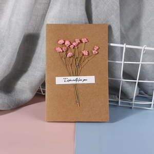 Close-up of handmade kraft card featuring pink dried gypsophila and Especially for you text