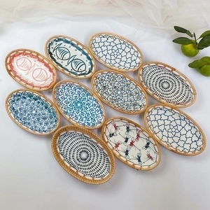 Japanese style hand-painted ceramic snack plates with woven rattan edges and floral patterns