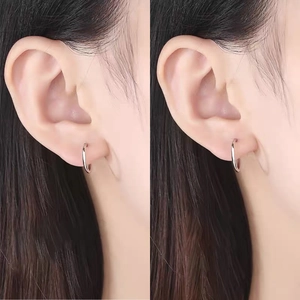 Detailed close-up showing a pair of minimalist s999 sterling silver hoop earrings on ears