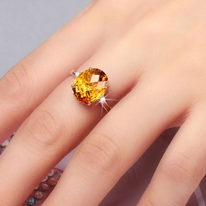 Elegant gold-plated ring with oval yellow citrine stone in a classic four-prong setting