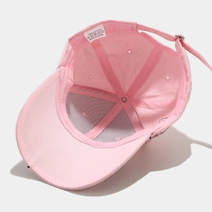 Pink cotton baseball cap interior detail with 100% cotton label and metal buckle