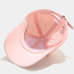Internal view of pink cotton baseball cap with adjustable metal buckle and seam details