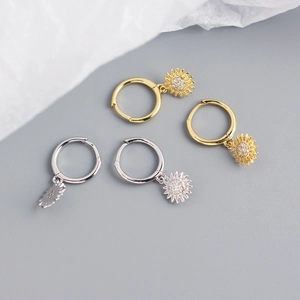 Detailed view of sunflower hoop earrings in gold and silver finish with crystal inlay