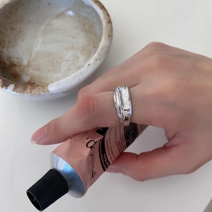 Detail of minimalist 925 silver ring featuring irregular lava texture worn on finger