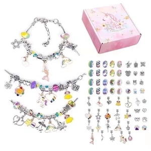 Detail of DIY ocean-themed charm bracelet kit with silver chains and unicorn gift box
