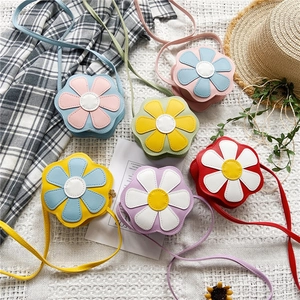 Detailed flat lay of flower-shaped PU leather crossbody bags in six vibrant pastel colors