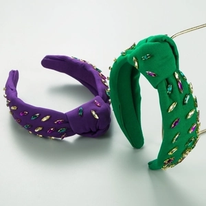 Detail of knotted headbands with colorful marquise crystals in purple and green fabrics