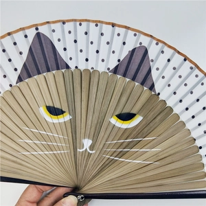 Detail of a Japanese folding fan featuring bamboo ribs shaped into a cute cat face motif