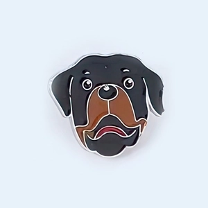 Close-up detail of Rottweiler dog enamel pin with black and brown colors in silver metal