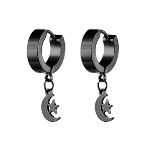 Macro shot of black punk star and moon charms on stainless steel huggie earrings