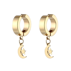 Detail of golden moon and star charms hanging from stainless steel hoop earrings