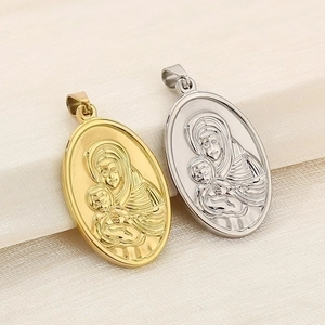 Macro detail of gold and silver religious pendant featuring Virgin Mary and Jesus relief