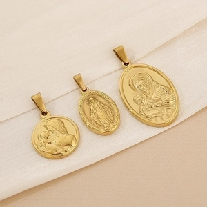 Religious vintage gold stainless steel pendants featuring portraits on beige fabric