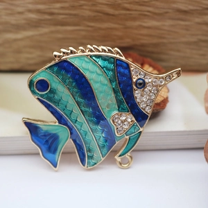 Detail of tropical fish brooch with blue enamel scales and rhinestone accents