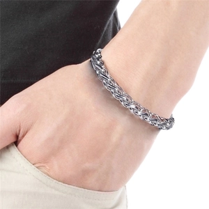 Men's titanium steel woven basket chain bracelet in silver finish on a male wrist