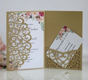 Detail of laser-cut gold wedding invitation set with floral patterns and RSVP card