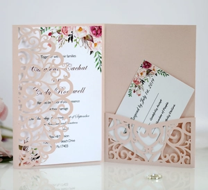 Pink laser-cut wedding invitation set featuring floral patterns and an RSVP card