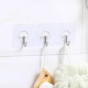 Strong transparent adhesive wall hooks with three metal hooks on white tile bathroom wall
