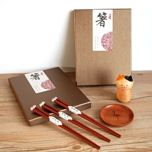 Detail of three pairs of wooden chopsticks with cute panda and koala animal heads