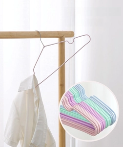 Close-up of non-slip dip-coated metal hanger with shoulder notches holding a shirt
