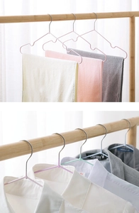 Detailed view of non-slip dip-coated hangers in pastel colors showing groove design