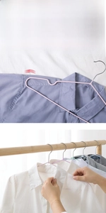 Detail of slim non-slip metal clothes hangers with plastic coating and shoulder grooves