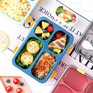 Blue multi-compartment plastic lunch box with yellow buckles and balanced meal inside
