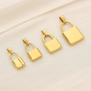Polished gold stainless steel lock pendants in four sizes displayed on silk background