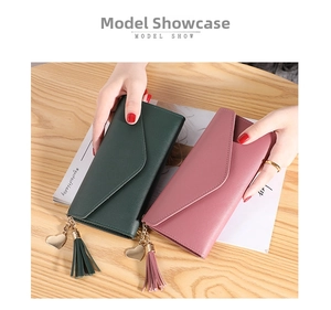 Deep green and dusty pink long wallets featuring heart pendants and tassel decorations
