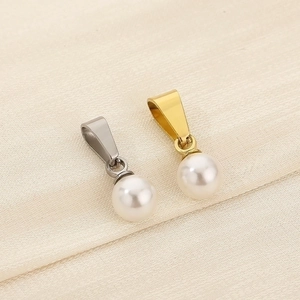 Macro view of gold and silver plated white pearl pendants for DIY jewelry making