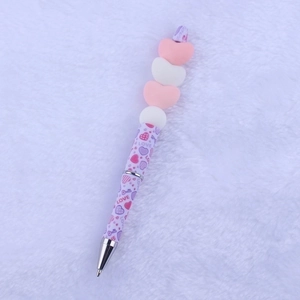 Macro detail of cartoon Valentine silicone beaded pen with purple love pattern