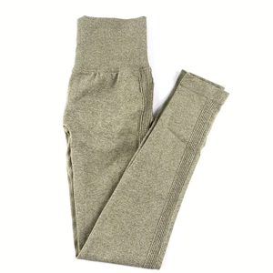 Detail of high waist seamless yoga pants featuring ribbed waistband and olive green knit