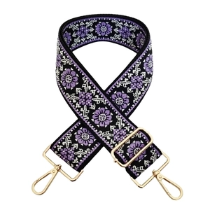 Close-up of ethnic jacquard strap with purple floral embroidery and gold metal hardware