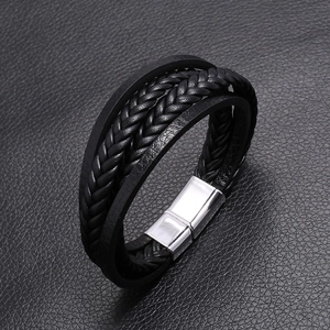 Detail view of multi-layer braided black leather bracelet with magnetic steel clasp