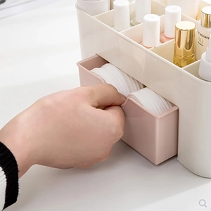 Cosmetic storage box with drawer showing skincare products and cotton pads organization