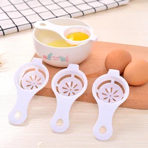 White PP egg separator set with petal-shaped filter and long handle on a wooden board