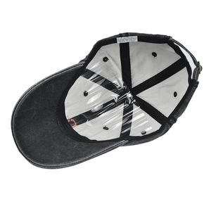 Inside view of a faded black denim baseball cap with reinforced seams and interior tags