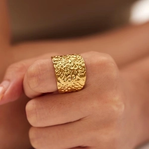 Detailed view of wide hammered texture 18K gold plated stainless steel ring for women