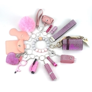 Pink 15-piece safety keychain set with plush ball, beaded wristlet and leather card holder