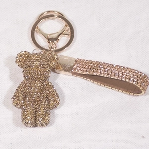 Detail of champagne gold rhinestone teddy bear keychain with matching woven crystal wrist strap