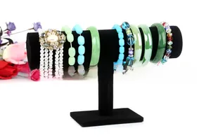 Detail view of T-bar jewelry display stand with black velvet finish and various bracelets