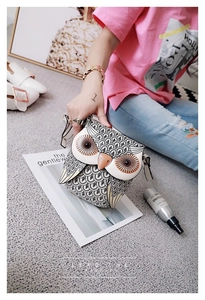 Detailed close-up of a creative owl shoulder bag with vivid black and white feather patterns