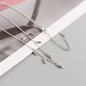 Macro view of silver S925 sterling silver necklace with mini crescent moon charms