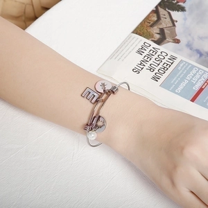 Silver stainless steel open bangle with letter E pendant and white pearl decoration
