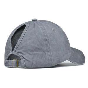 Detail of washed grey cotton baseball cap with ponytail opening and metal buckle